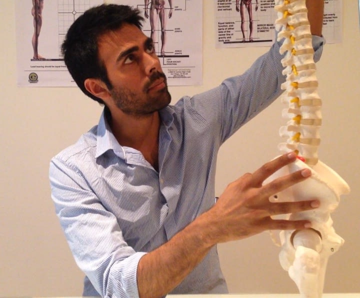 Posture Specialist holding a spine